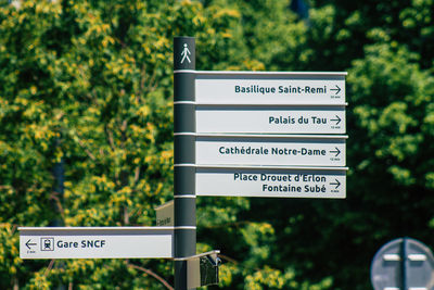 Close-up of road sign against trees