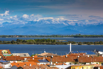 High angle view of townscape by sea against sky