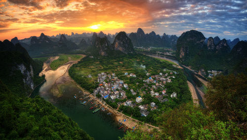 High angle view of plants and landscape against sky during sunset