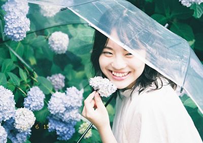Portrait of a smiling beautiful young woman in rain