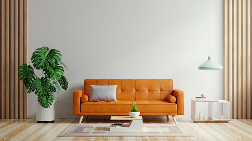 Living room have orange leather sofa and decoration minimal.3d rendering