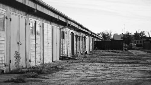Houses by building against sky