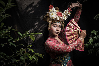 Portrait of woman in traditional clothing against tree