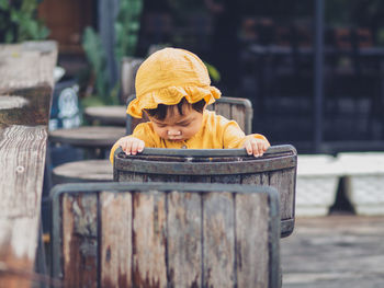 Portrait of young man sitting on wood