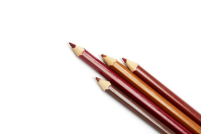 Close-up of colored pencils against white background