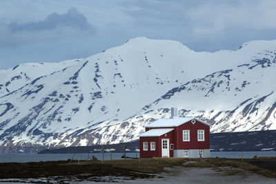 Red house at the fjords of north iceland, wintertime