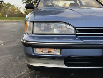 Close-up of car parked on road