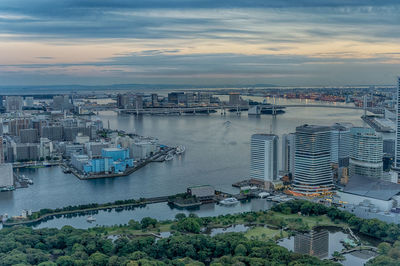 High angle view of buildings by sea against sky