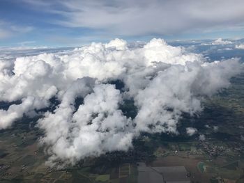 Aerial view of clouds over landscape against sky