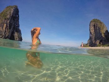 Low section of woman swimming in sea