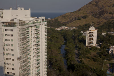 High angle view of buildings by sea against sky