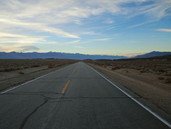 Road by landscape against sky