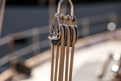 Close-up of metal hanging on rope