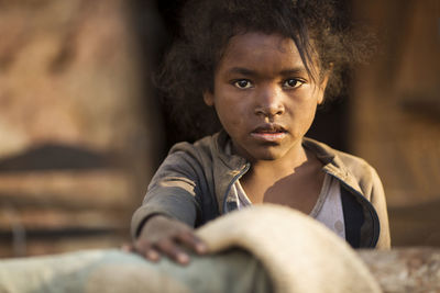 Portrait of teenage girl sitting outdoors