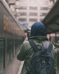 Rear view of man standing in city