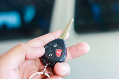 Cropped hand holding car key