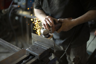 Midsection of man working at workshop