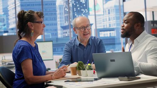 Side view of business colleagues working at office