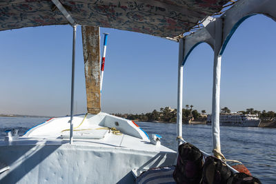 Sailboat sailing in sea against clear sky