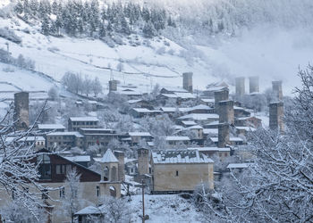 Snow covered houses and buildings in city