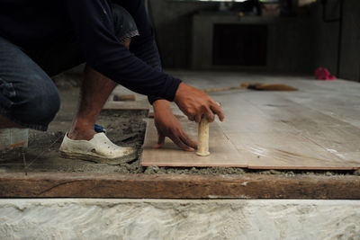 Midsection of man working in tray