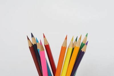 Close-up of colored pencils against white background