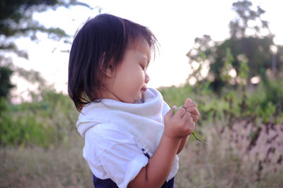 Cute girl looking away on field