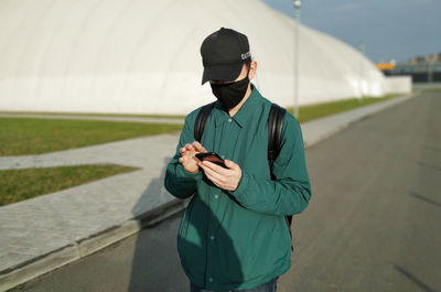 Man using mobile phone while standing on street