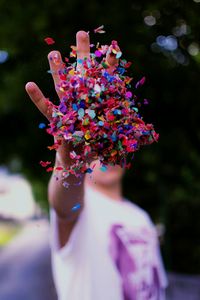 Close-up of man with multi colored confetti