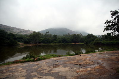 Scenic view of lake and mountains against sky