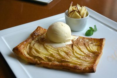 Close-up of apple pie with ice cream in plate