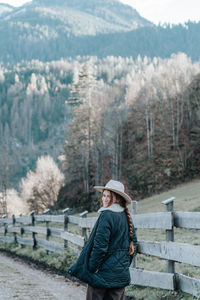 Portrait of woman standing against mountain