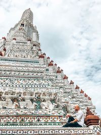 View of temple building against cloudy sky