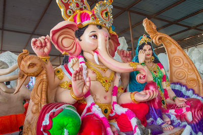 Low angle view of statue against temple