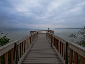 Pier over sea against sky