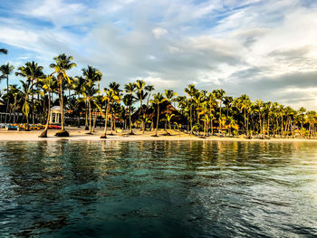 View of swimming pool in sea against cloudy sky