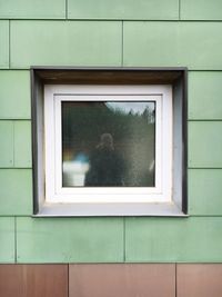 Reflection of person on frosted glass