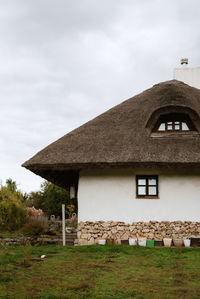 Built structure on field against sky