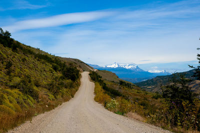 Scenic view of road amidst mountains against sky