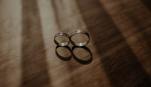 Close-up of wedding rings on table