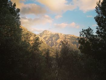 Scenic view of mountains against cloudy sky