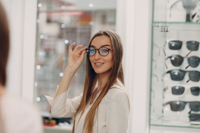 Portrait of smiling young woman in store