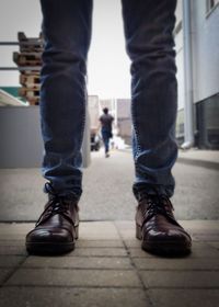 Low section of man and woman standing on footpath