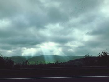 Scenic view of landscape against storm clouds