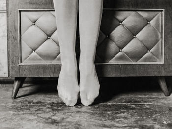 Low section of ballet dancer standing on floor