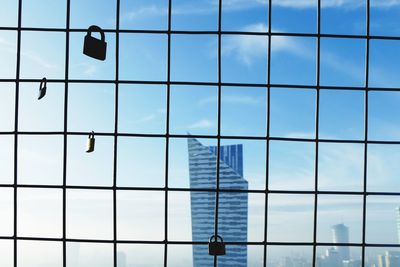 Close-up of glass window against sky