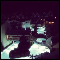 Illuminated buildings against sky at night