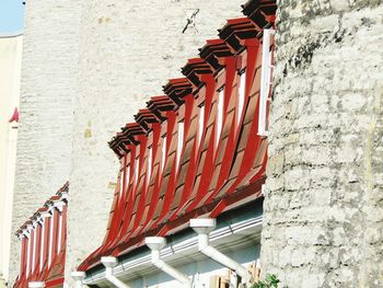 Red railing against brick wall