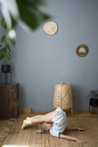 Girl practicing yoga at home