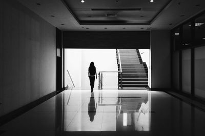 Woman walking towards staircase